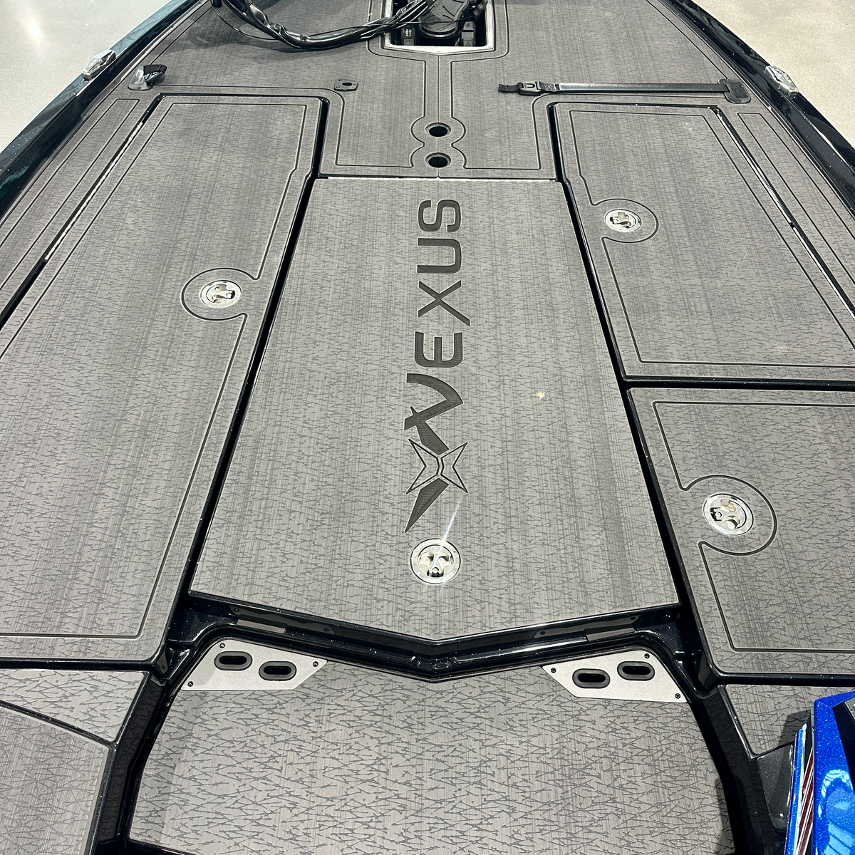 Bow casting deck of the 2025 Vexus VXS20 with gray non-skid, Vexus logo and flush storage hatches — Lake & Trail USA, Okeechobee FL