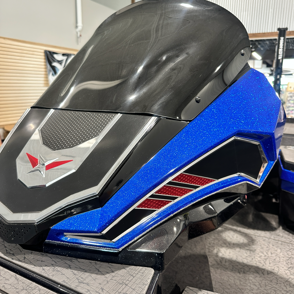 Bow cap of the 2025 Vexus VXS20 — smoked windscreen, blue metal flake and chrome Vexus star badge — Lake & Trail USA, Okeechobee FL
