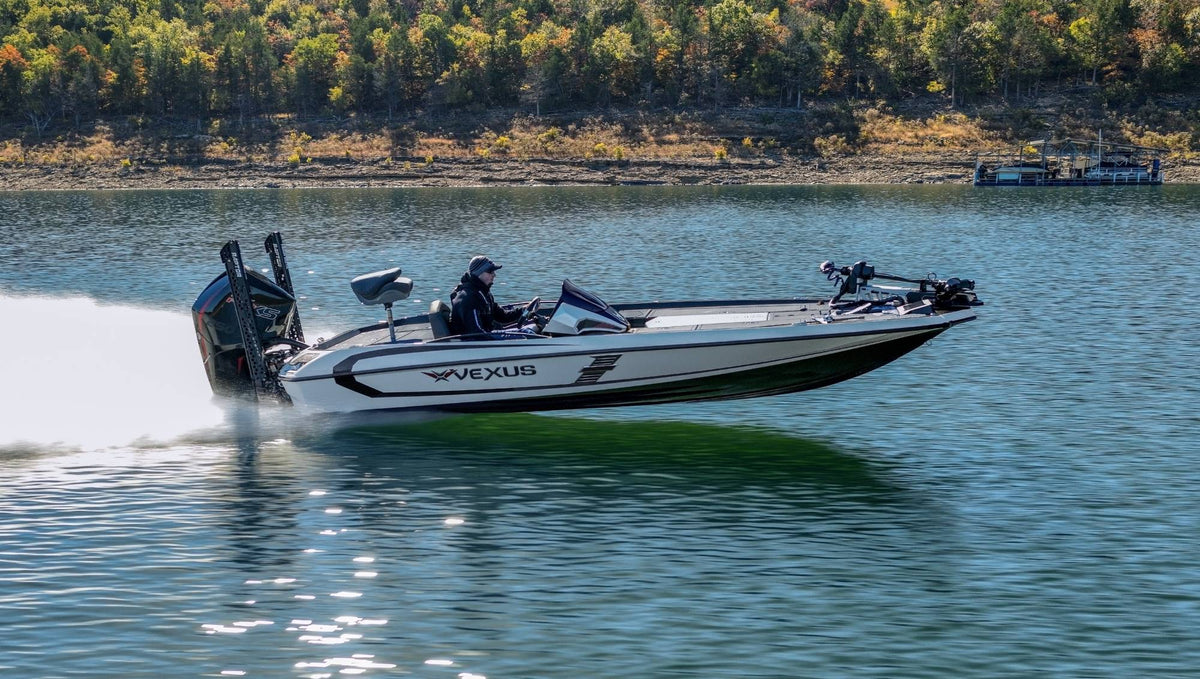 Vexus VXS20 — manufacturer photo, profile on the water with a shoreline behind